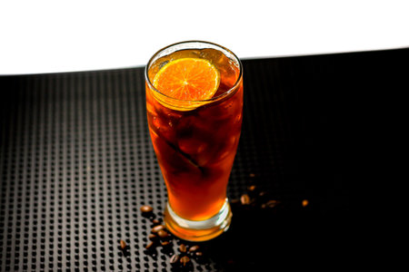 Cuba libre cocktail with orange on black background