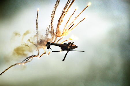 an helicopter falling down the sky with explosionの写真素材