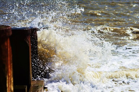 Waves crashing against a breakerの写真素材