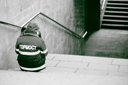 an employee of the Moscow Gormost service sits on the steps of an underground passage during the cavid-19 quarantine in the East of Moscow 10.04.2020 black and whiteのeditorial素材