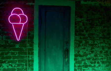 A neon ice cream figure on a brick wallの写真素材