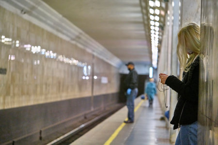 Russia Moscow June 2020. Moscow metro. a girl in a protective mask rides waiting for a metro train...