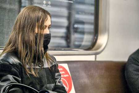 Russia Moscow June 2020. Moscow metro. people in protective masks ride in a subway car. coronavirus epidemic in Russia. viral risk of infection. colorのeditorial素材