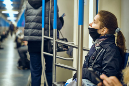 Russia Moscow June 2020. Moscow metro. people in protective masks ride in a subway car. coronavirus epidemic in Russia. viral risk of infection. colorのeditorial素材
