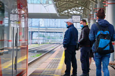 Moscow June 2020 people in medetsin masks stand waiting for a train of the Moscow central ring. The corona virus epidemic in Russiaのeditorial素材