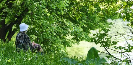 a woman in a medical mask rests in nature. Epidemic Corona Virus in Russia colorの写真素材