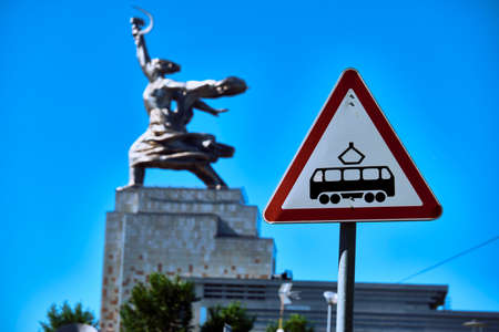 Moscow June 2020. sign cautiously tram against the background of the monument to the worker and collective farm on the day colorのeditorial素材