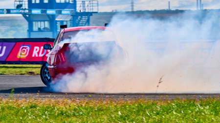 Russia Ryazan International Track Atron September 2020. A sports car in a controlled skid on the track. Smoke billows from under the wheelsのeditorial素材