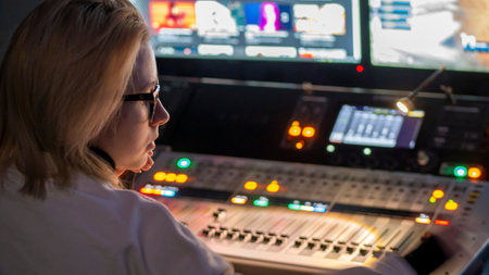 Russia October 2020. the girl sound engineer works works on the broadcast at the sound console. low lightのeditorial素材