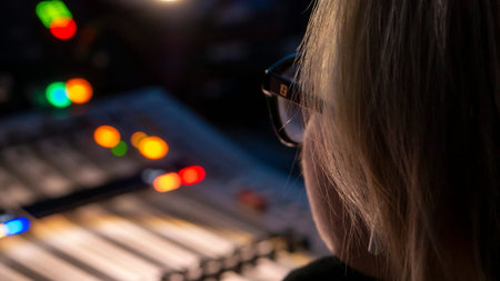 Russia October 2020. the girl sound engineer works works on the broadcast at the sound console. low...