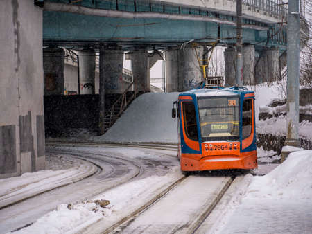 Moscow, Russia january 2022. The tram moves along the snow-covered city street.のeditorial素材