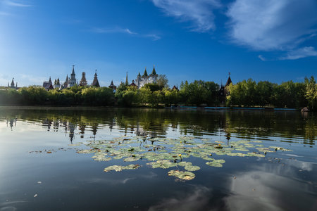 Moscow, Russia 2022. Izmailovo Kremlin on the lake shore in summer framed by tree branches,のeditorial素材