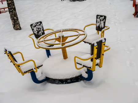 The playground in the courtyard of a residential building is buried under a large layer of snow, winter weatherの写真素材