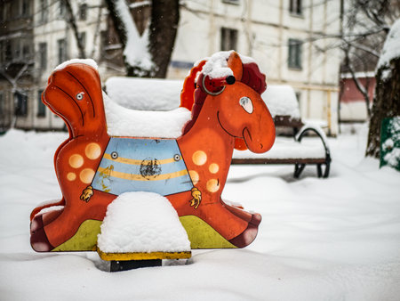 The playground in the courtyard of a residential building is buried under a large layer of snow, winter weatherの写真素材