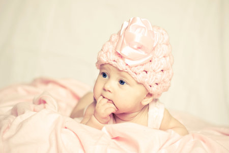 baby girl in a pink hatの写真素材