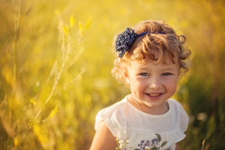 Smiling little girl on the fieldの写真素材