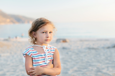 Adorable happy smiling little girl on beach vacationの写真素材