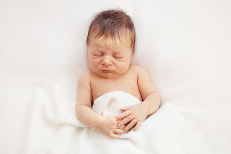 healthy newborn baby one week old sleepingの写真素材