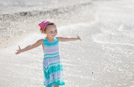 Adorable happy smiling little girl on beach vacationの写真素材