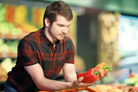 A young man shopping for fruit and vegの写真素材