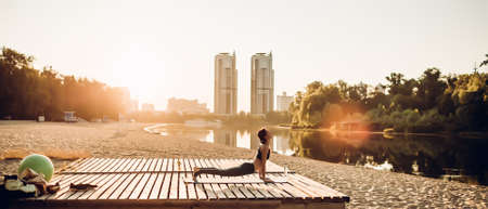 Sportswoman do yoga at sunriseの写真素材