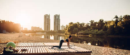 Sportswoman do yoga at sunriseの写真素材