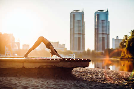 Sportswoman do yoga at sunriseの写真素材