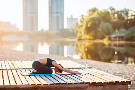 Sportswoman do yoga at sunriseの写真素材