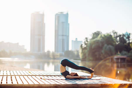 Sportswoman do yoga at sunriseの写真素材