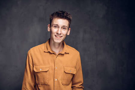 Happy young caucasian man on dark backgroundの写真素材