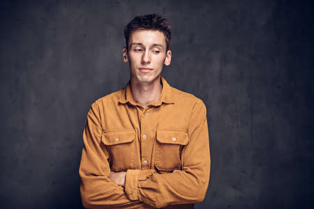 Pensive young caucasian man on dark backgroundの写真素材
