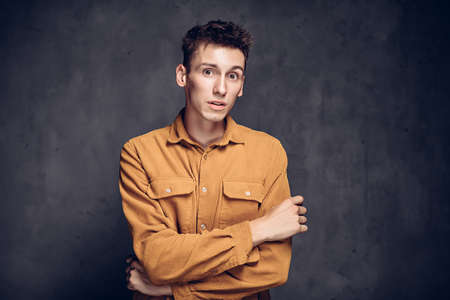 Surprised young caucasian man on dark backgroundの写真素材
