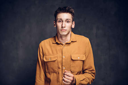 Frightened young caucasian man on dark backgroundの写真素材