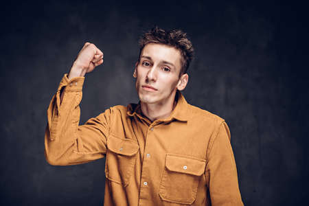 Angry young caucasian man on dark backgroundの写真素材