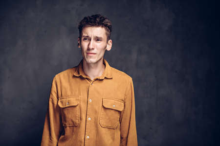 caucasian man with headache on dark backgroundの写真素材