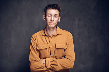 Pensive young caucasian man on dark backgroundの写真素材