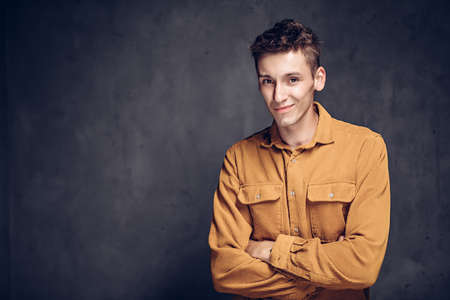 Joyful young caucasian man on dark backgroundの写真素材