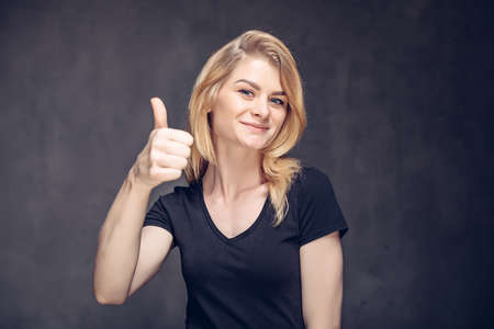 Young caucasian woman show thumb upの写真素材