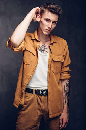Serious young caucasian man on dark backgroundの写真素材