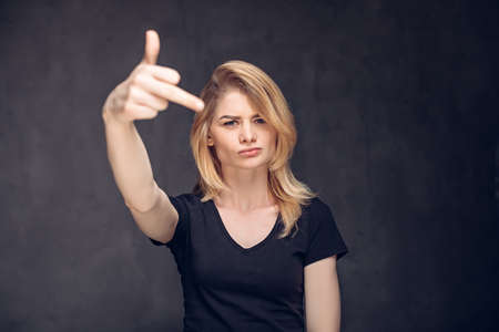 Young caucasian woman show middle fingerの写真素材