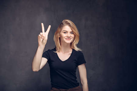 Young caucasian woman show victory gestureの写真素材