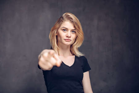 Young caucasian woman point with fingerの写真素材