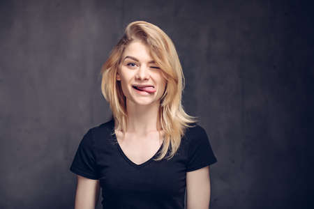 Young caucasian woman sticking out tongueの写真素材