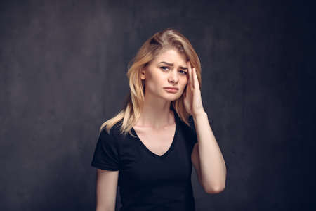 Tired young caucasian woman with headacheの写真素材