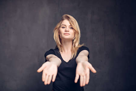 Young caucasian woman outstretched handsの写真素材