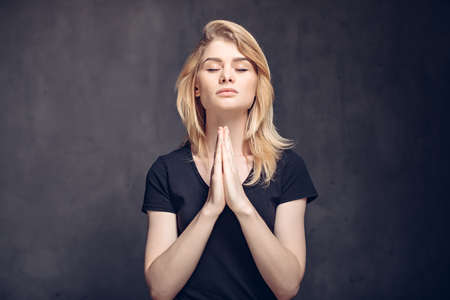 Young caucasian woman prayの写真素材