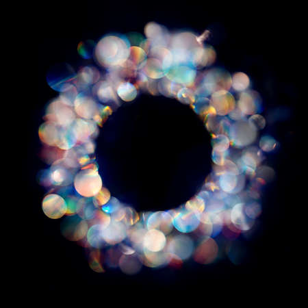 Multiple neon colored iridescent bokeh spots in round frameの写真素材