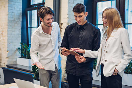 Businesspeople looking on tablet in officeの写真素材