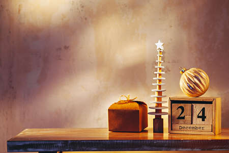 Simple image with christmas tree, gift, ornament and wooden calendarの写真素材