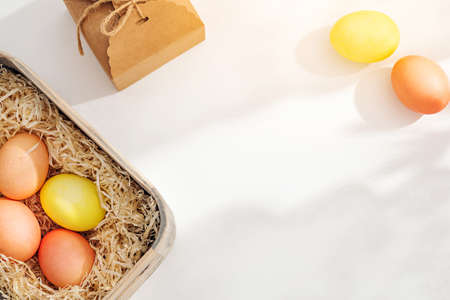 Easter eggs in the sunlight on the white table near the window. Bright spring Easter backgroundの写真素材